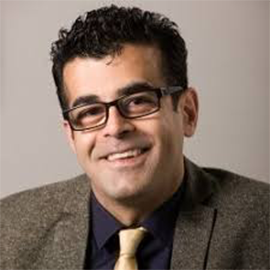 Man wearing glasses smiling at the camera