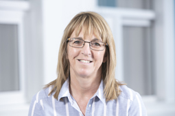 a woman standing in front of a window