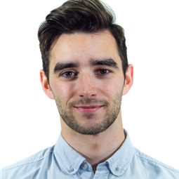 a man wearing glasses posing for the camera