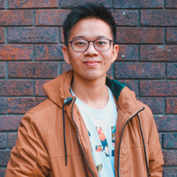 a person standing in front of a brick building