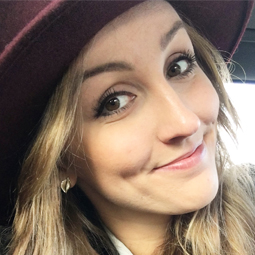 a close up of a woman wearing a hat