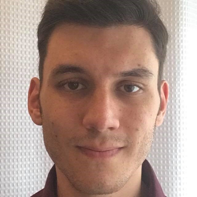 a man wearing glasses posing for the camera