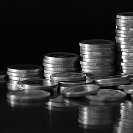 Black and white image of coins stacked in a row