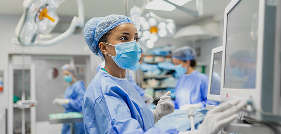 Nurse in surgery room checking a monitor