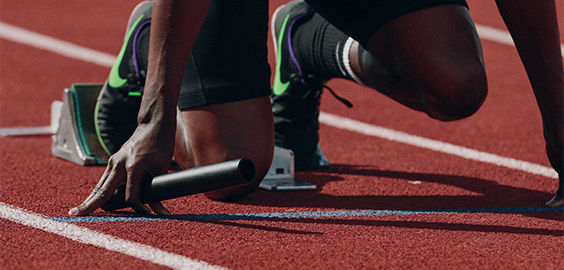 runner in starting position on race track