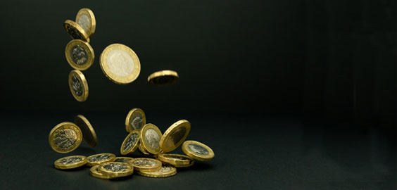 British pound coins being falling down into a pile