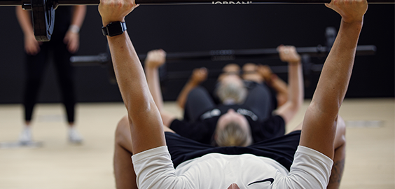 Man lifting weights in a class