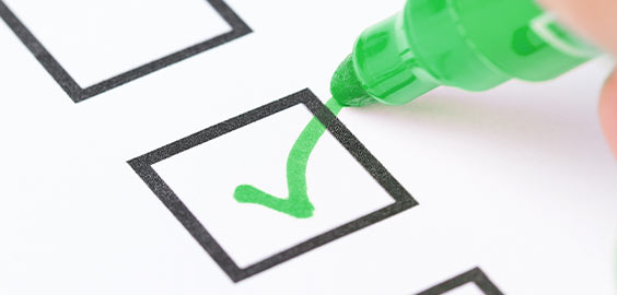 Green marker ticking a checklist