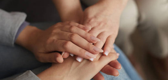 Image of hands being held together