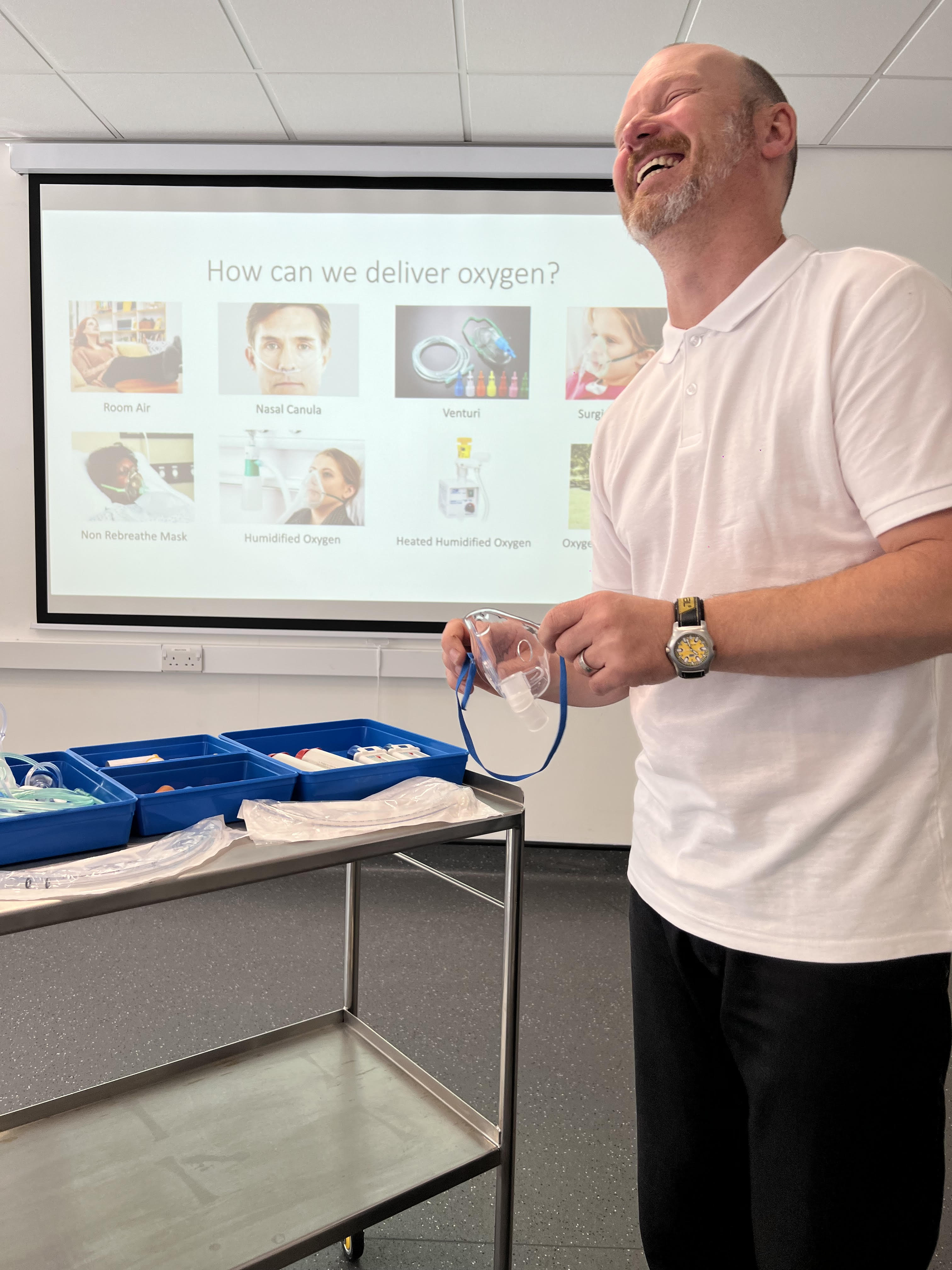 man holding oxygen masks laughing