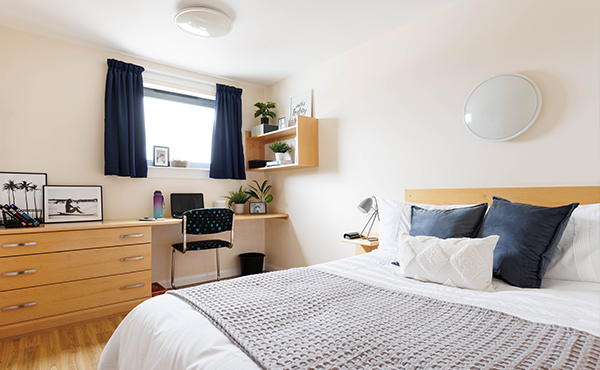 Trinity Square en-suite bedroom with a double bed, decorated with personal items