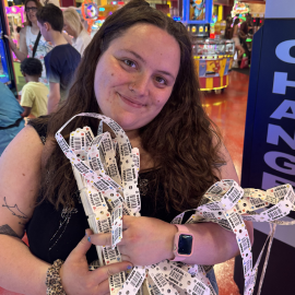 girl smiling holding tokens