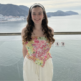 girl smiling infront of the sea