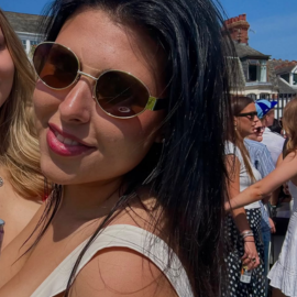 girl smiling with sunglasses on