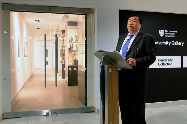 Cesar Virata in a suit standing in front of a mirror
