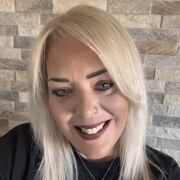 Blond Woman smiling into the camera.