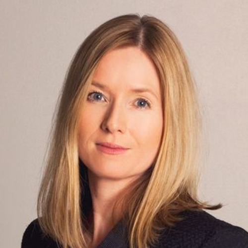 Photograph of blonde woman looking at the camera.