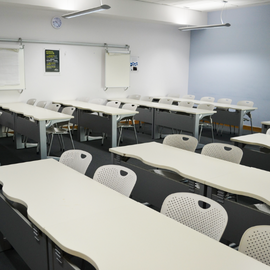 Classroom with white desks and chairs