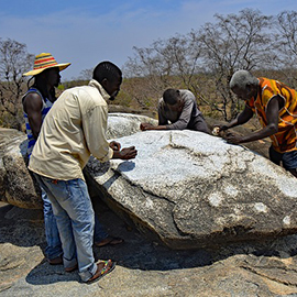 a group of people on a rock