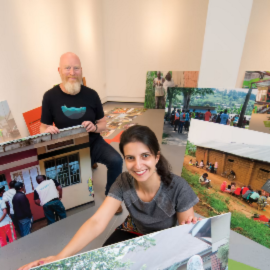 Professor Matt Baillie Smith and Dr Bianca Fadel help install the RYVU exhibition at Gallery North.