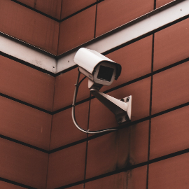 CCTV security camera on the red brick stone wall