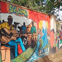 Colourful mural on wall including man playing guitar