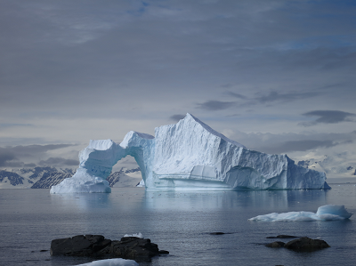 bridge shaped iceberg in artic ocean