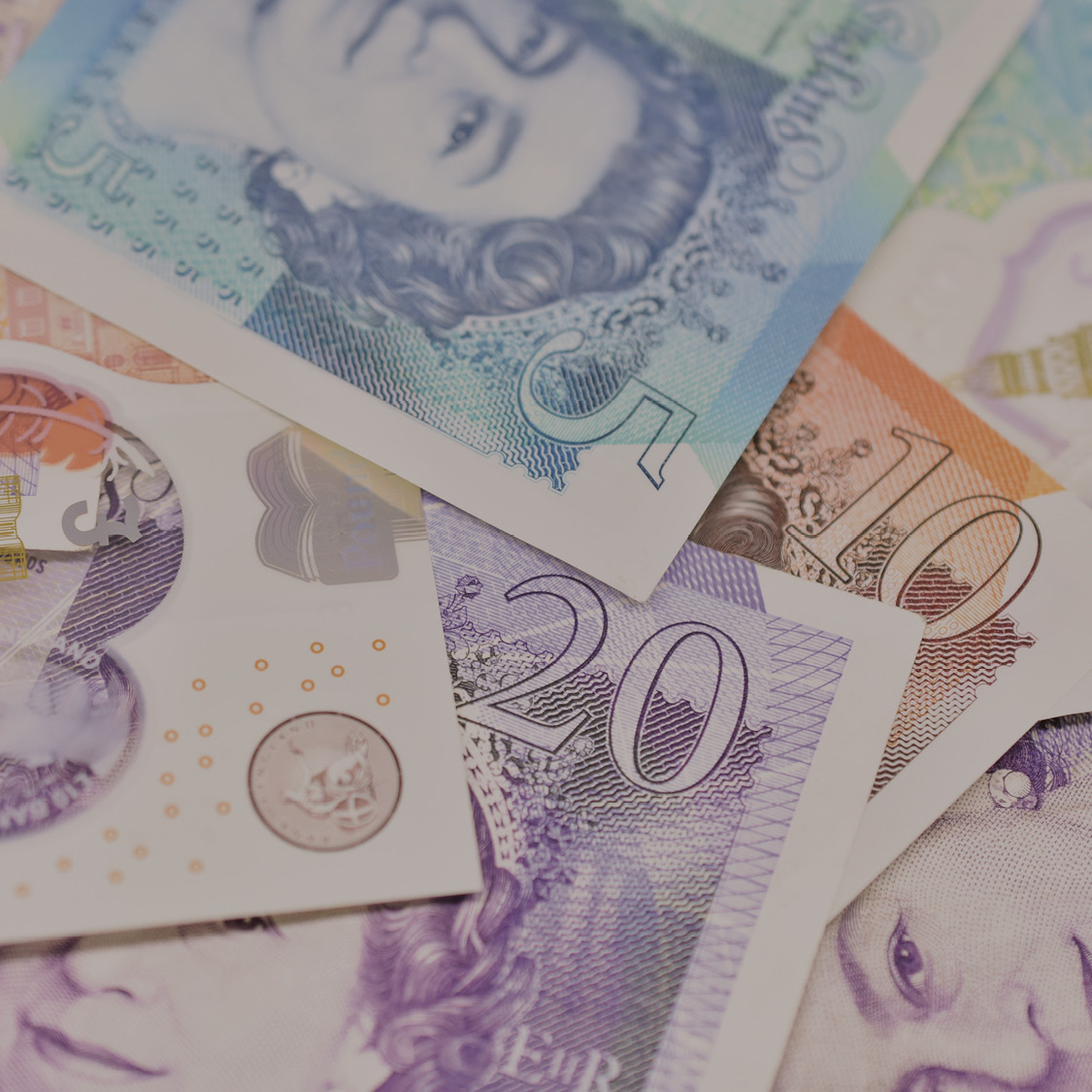 UK banknotes and coins representing student financial support