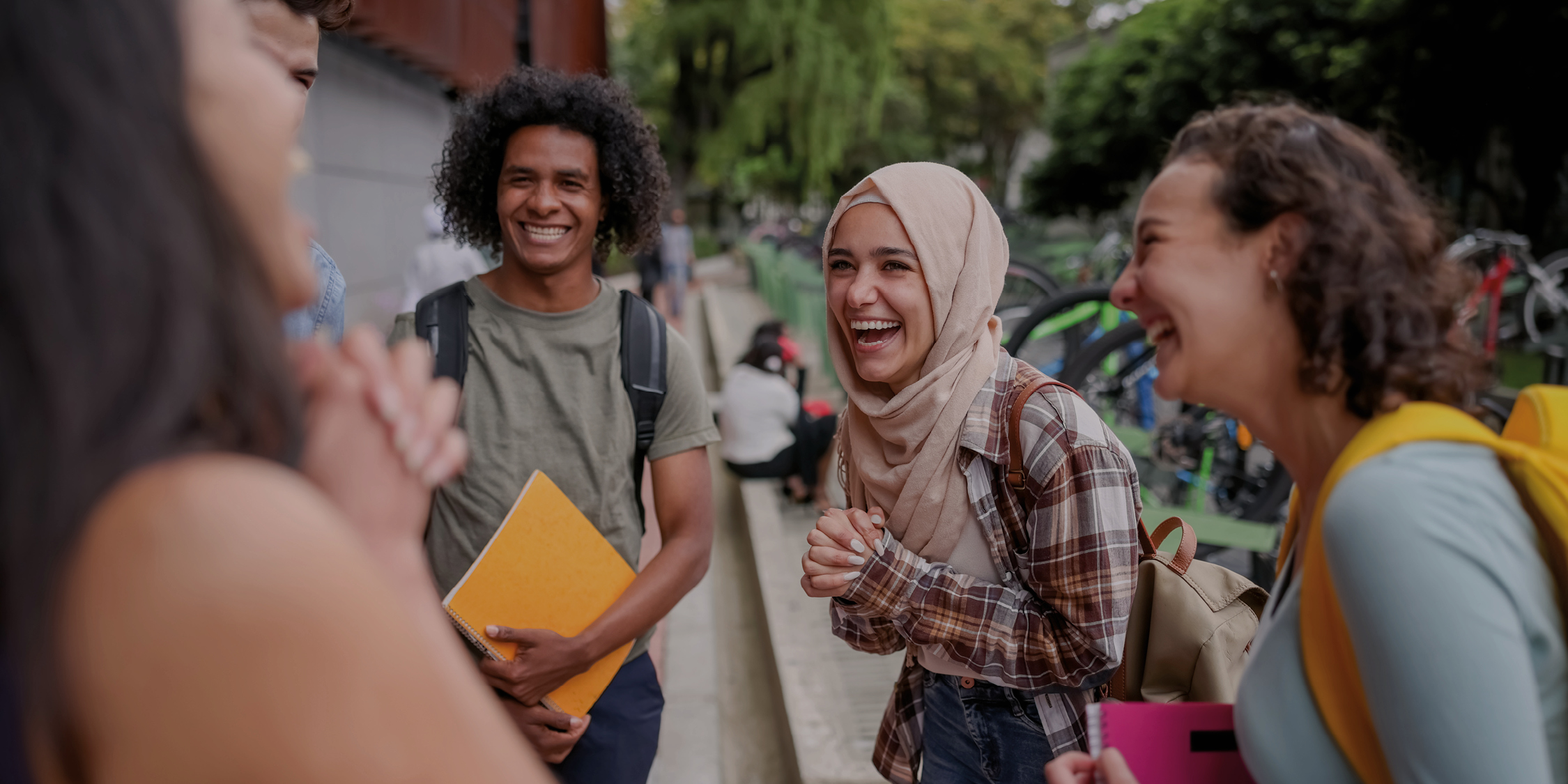 Students chatting together outdoors on campus