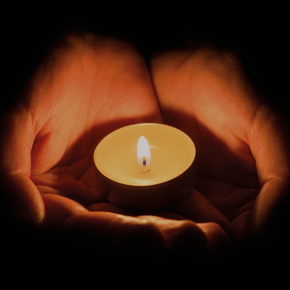 Tealight candle held in hands