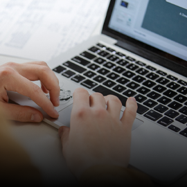 hands typing at a laptop keyboard