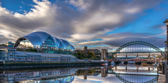 a train crossing Sage Gateshead over a body of water