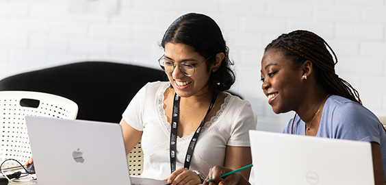 Two female students studying on their laptops