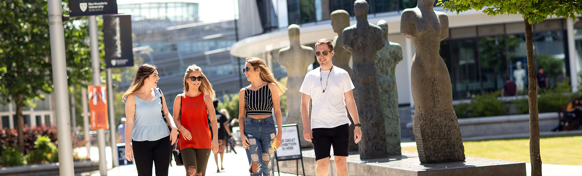 a group of people walking on a sidewalk