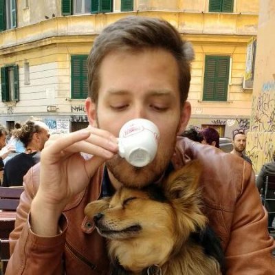 person drinking coffee with dog