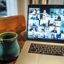 Open laptop sat on desk with microsoft teams meeting in place.