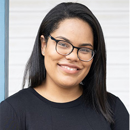 a person standing in front of a window posing for the camera