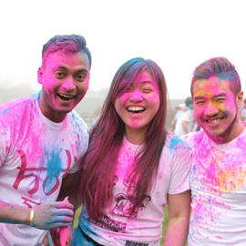3 people covered in paint laughing