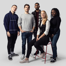 Group of students looking at camera in studio