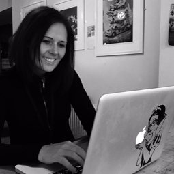 Black and white image of woman using laptop