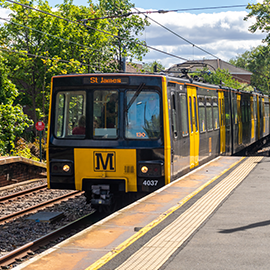 Tyne and Wear Metro approaching a platform at a station