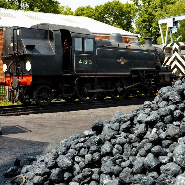 steam train next to pile of coal