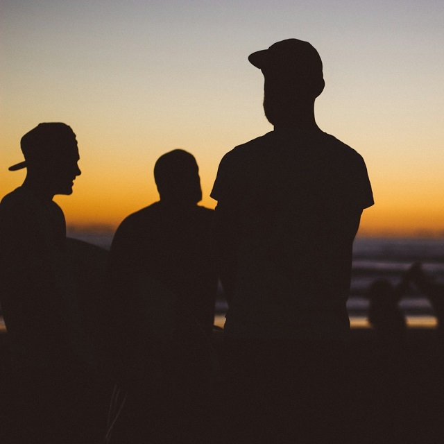 silhouette of three young men