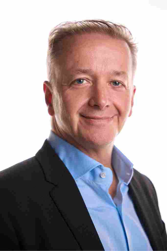 Tony Wells. smiling to camera with white background 