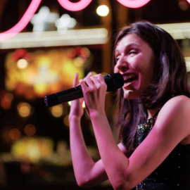 a laughing woman holding a microphone