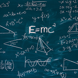 Blackboard inscribed with scientific formulas and calculations in mathematics.